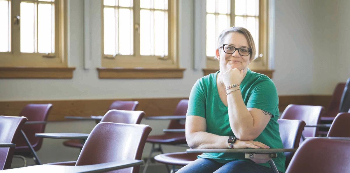 Jennifer Hayden smiles while seated at a desk.